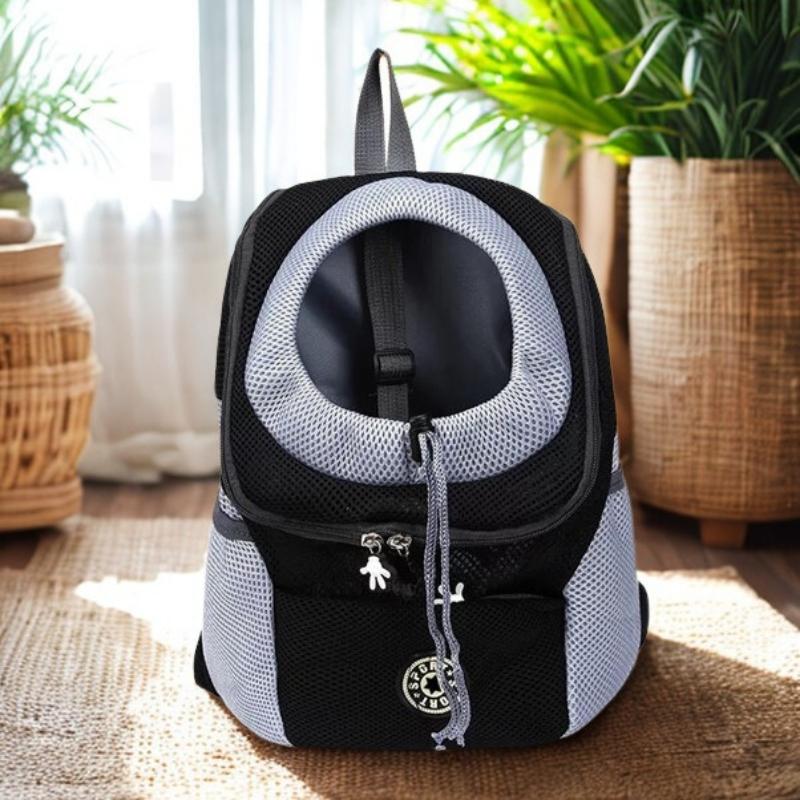 Black and gray pet carrier backpack on a wooden floor with plants in the background