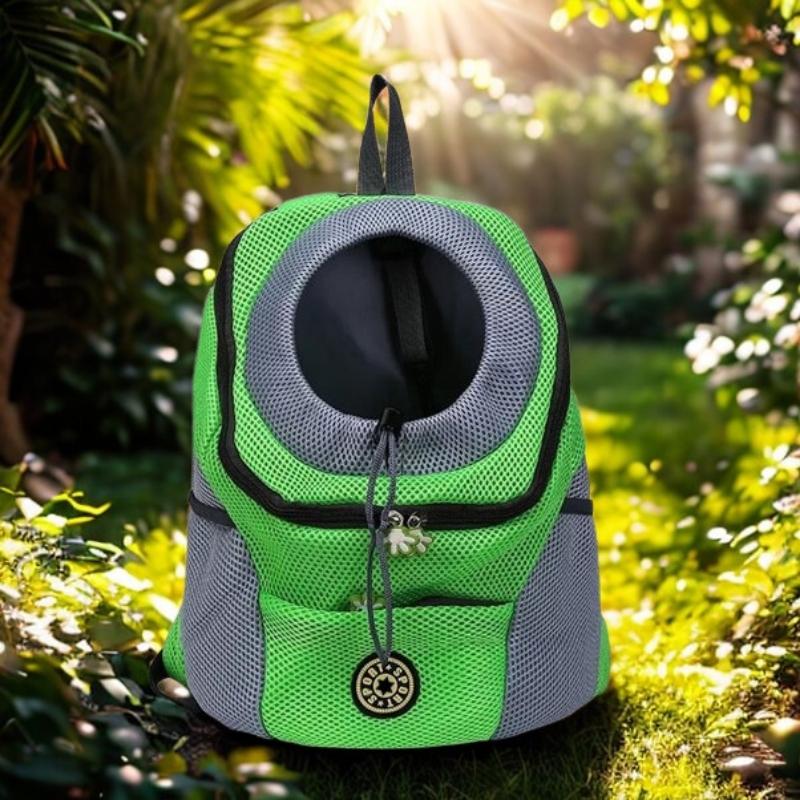 Green and gray pet carrier in a natural setting with sunlight filtering through leaves.