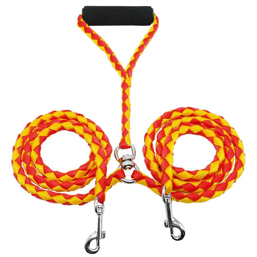 Red and yellow braided double dog leash with metal clips on a white background