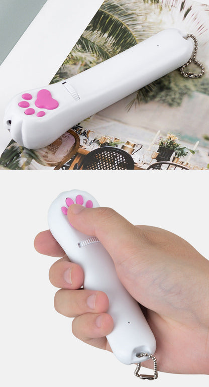 PawBeam with pink paw switch held by a hand on a white background