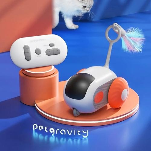 Remote-controlled smart cat toy in orange with remote and cat in background