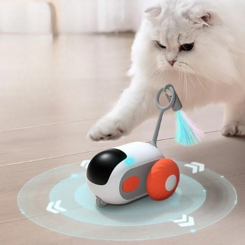 Remote-controlled smart cat toy spinning on the ground with a cat playing