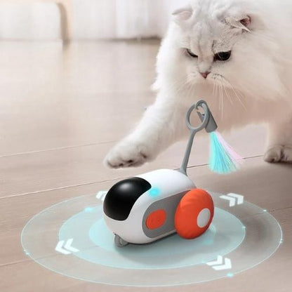 Remote-controlled smart cat toy spinning on the ground with a cat playing