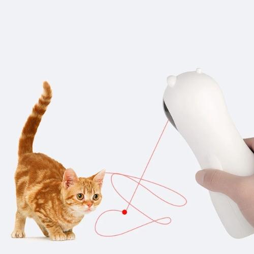 Laser Kitty Auto Chaser showing hand holding toy and ginger cat playing with handheld mode laser beam