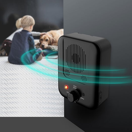 Dog sitting calmly with children near BarkLogic bark control unit in hallway


